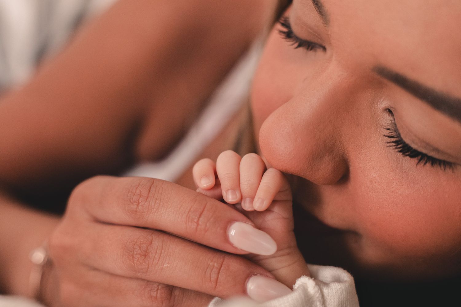 A parent holding their baby close, skin to skin